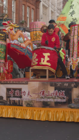 Vertical-Video-Of-Crowds-At-Parade-With-Float-Around-Trafalgar-Square-In-London-UK-In-2023-To-Celebrate-Chinese-New-Year-